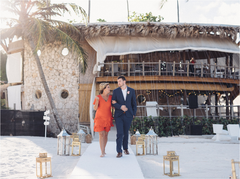 groom walks down the aisle with mom